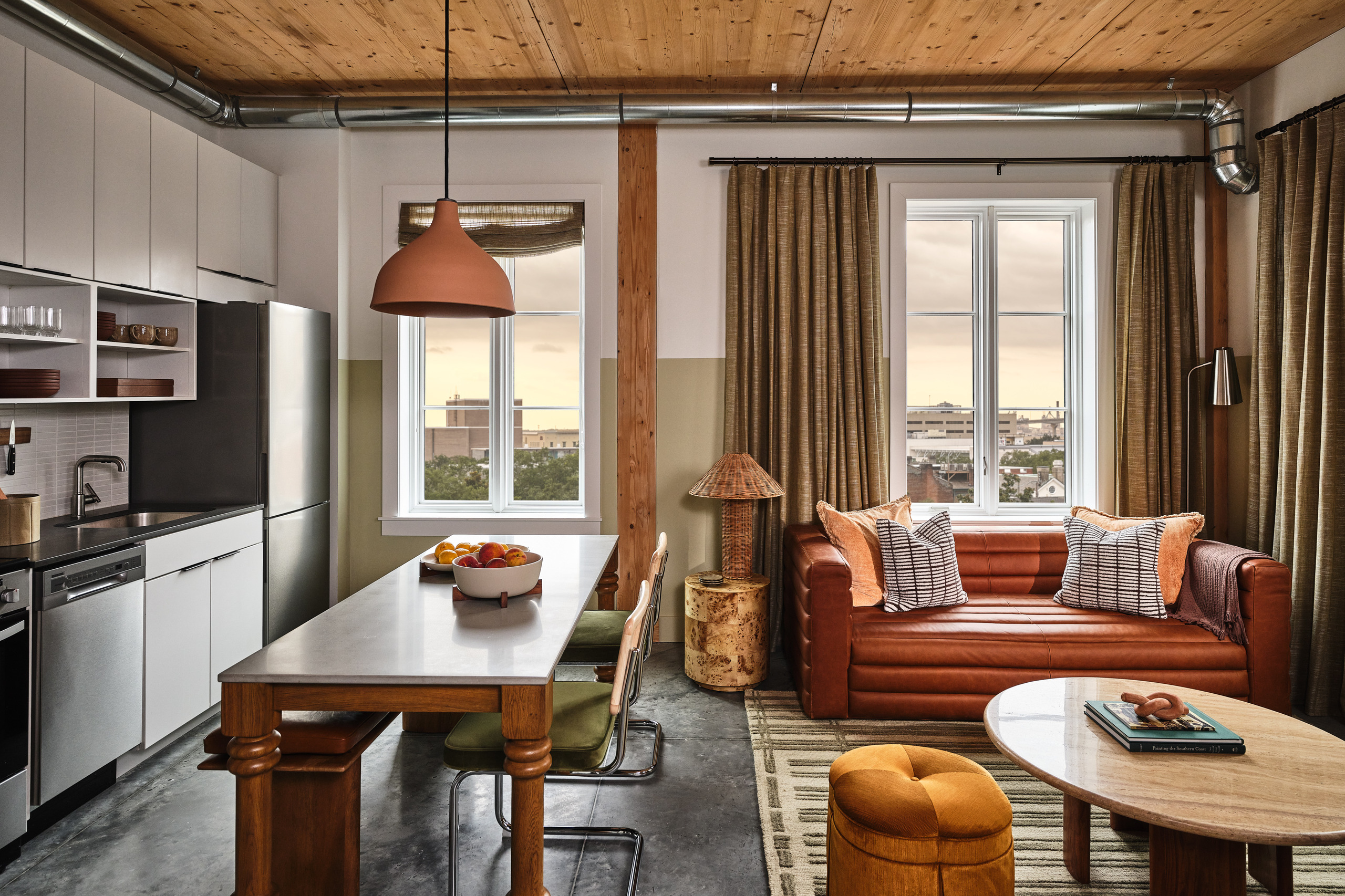 Guest suite inside The Ann Savannah showing its mass-timber ceiling, kitchen and living area.