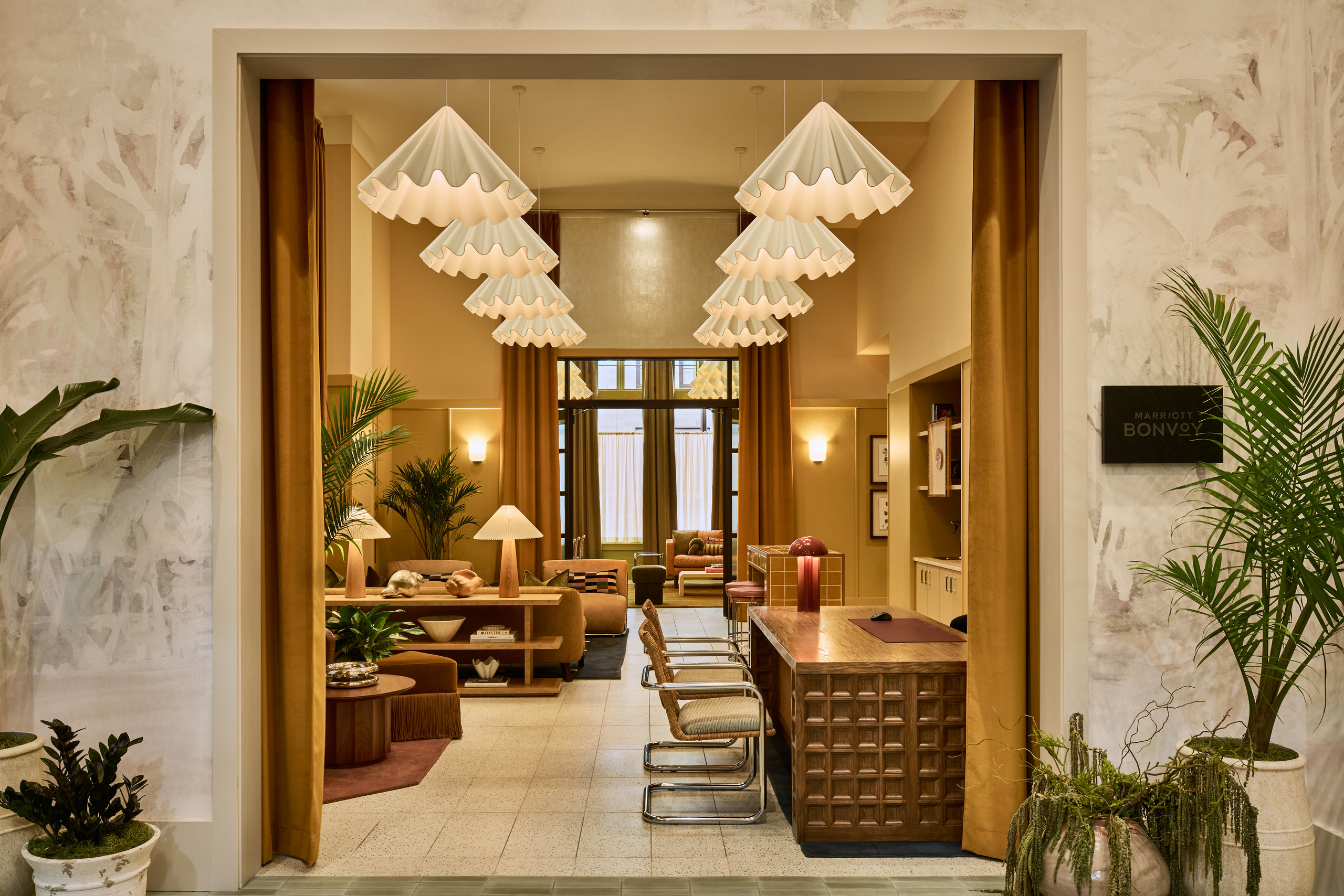 The Ann Savannah hotel lobby with reception desk, lounge seating and Marriott Bonvoy sign.